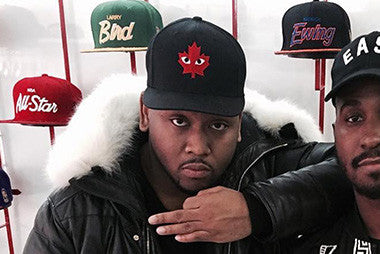 Boi1da wearing CDG Snapback